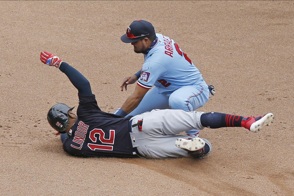 Cleveland Indians' Francisco Lindor, left, is tagged out at second base by Minnesota Twins second baseman Luis Arraez as he tried to stretch an RBI-single into a double in the fourth inning of a baseball game Sunday, Aug. 2, 2020, in Minneapolis. (AP Photo/Jim Mone)