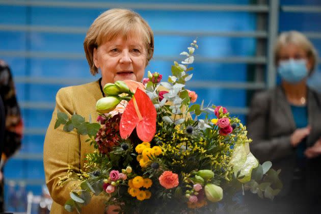 German Chancellor Angela Merkel holds a bouquet of flowers she was given prior to the cabinet meeting at the Chancellery in Berlin, Germany, on November 24, 2021. - Merkel was given flowers as this was probably her last cabinet session as German Chancellor as negotiations are going on to form a new government after elections were held in September. (Photo by Markus Schreiber / POOL / AFP) (Photo by MARKUS SCHREIBER/POOL/AFP via Getty Images) (Photo: MARKUS SCHREIBER via Getty Images)