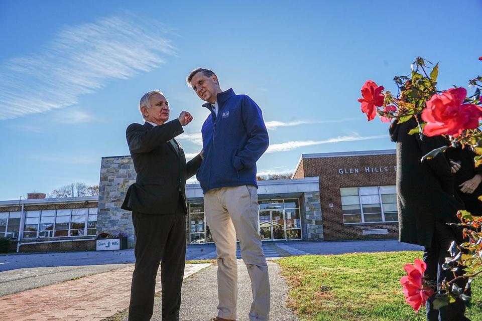 Democrat Seth Magaziner, seeking the U.S. House seat in Rhode Island's Second Congressional District, chats on Tuesday with Democratic U.S. Sen. Jack Reed, D-RI, at Glen Hills Elementary School in Cranston.