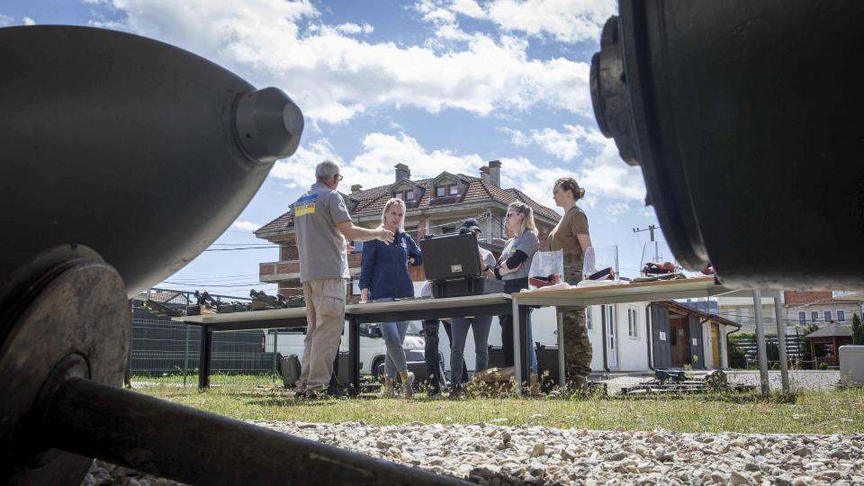 Demining instructor Artur Tigani, left, briefs a group of Ukrainian female emergency services personnel for specialist training in explosive ordnance disposal and survey training in the western Kosovo city of Peja on Monday, April 25, 2022. Six Ukrainian women have started to be trained in Kosovo to dispose of explosive ordnance that have contaminated their country invaded by Russia. (AP Photo/Visar Kryeziu)