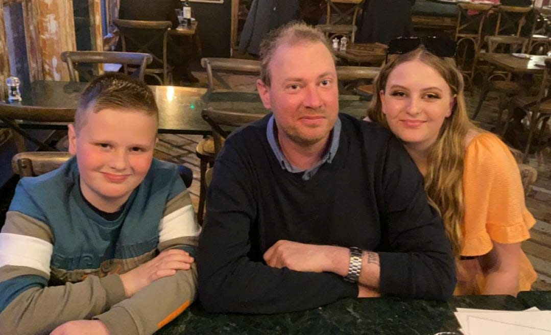 Voice suffered dizzy spells and headaches for seven years before being diagnosed with a brain tumour, pictured with his children Mason and Darcy. (Matthew Voice/SWNS)