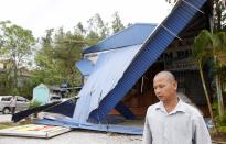 A man walks in front of his damaged restaurant at Ha Long Bay in the aftermath of typhoon Haiyan in Vietnam's northern Quang Ninh province, 180 km (112 miles) from Hanoi November 11, 2013.