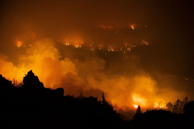 In this long exposure photograph, smoke and flames can be seen burning on both sides of the Christmas Valley area during the Caldor fire near Meyers, Calif., on August 30, 2021. File Photo by Peter DaSilva/UPI