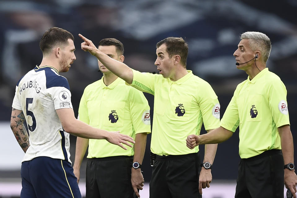 Tottenham's Pierre-Emile Hojbjerg, left, talks to referee Peter Bankes during the English Premier League soccer match between Tottenham and Newcastle at the Tottenham Hotspur Stadium in London, Sunday, Sept. 27, 2020. (Daniel Leal-Olivas/Pool via AP)