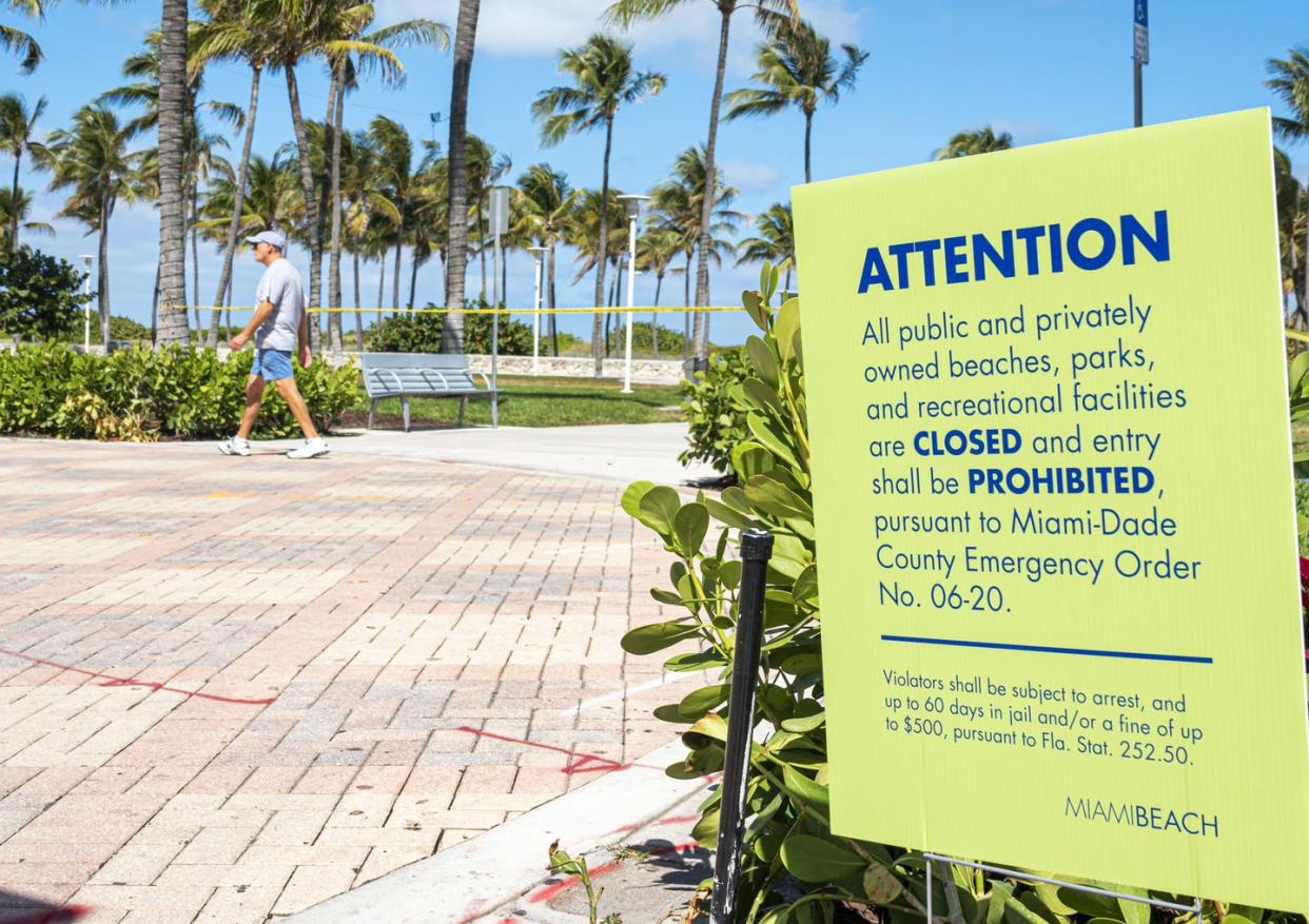 <span class="caption">Plenty of warm and humid places – including Miami – are seeing the spread of SARS-CoV-2.</span> <span class="attribution"><a class="link " href="https://www.gettyimages.com/detail/news-photo/miami-beach-lummus-park-closed-due-to-pandemic-sign-and-man-news-photo/1217550661" rel="nofollow noopener" target="_blank" data-ylk="slk:Jeff Greenberg/Universal Images Group via Getty Images;elm:context_link;itc:0;sec:content-canvas">Jeff Greenberg/Universal Images Group via Getty Images</a></span>