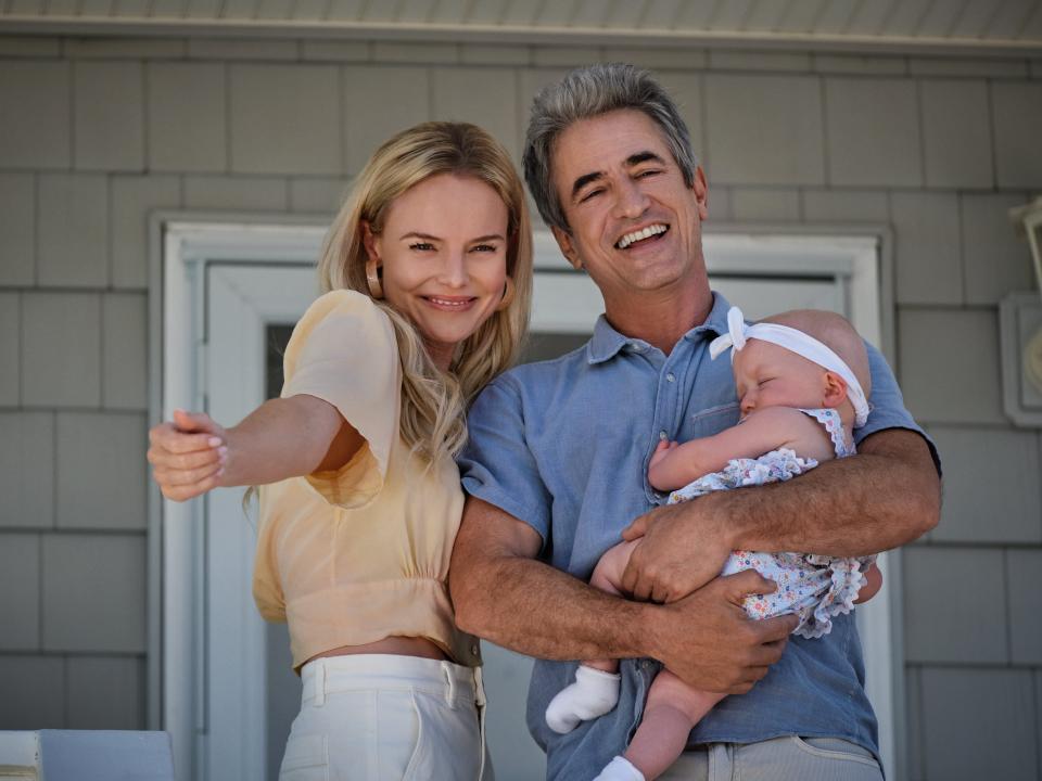 characters from along for the ride standing on a porch holding a baby