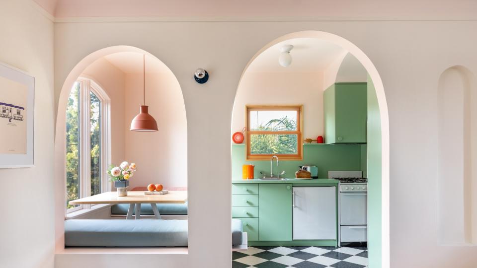 Laurel Broughton replaced rectangular doorways and detailing with elegant arches, inspired in part by an original niche located just to the right of the kitchen entry.