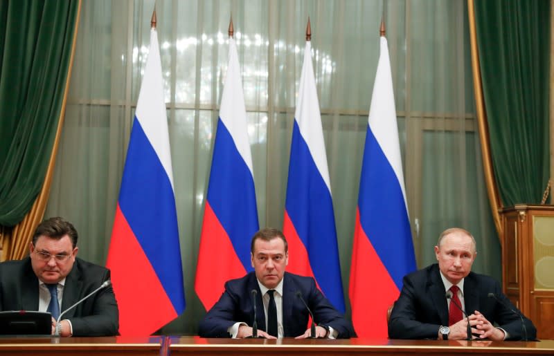 Russian President Putin and Prime Minister Medvedev attend a meeting with members of the government in Moscow