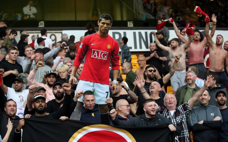 Manchester United fans celebrate with a cardboard cut out of Cristiano Ronaldo - Reuters