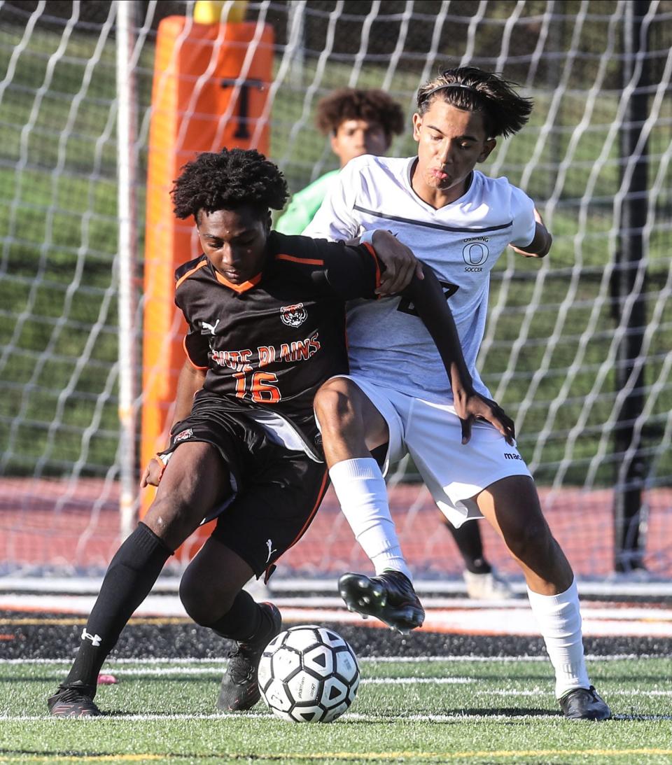 Alexander Rhaymani of White Plains battles Randy Vallejo of Ossining during a varsity soccer match at White Plains High School Oct. 6, 2022. Ossining defeated White Plains 1-0.