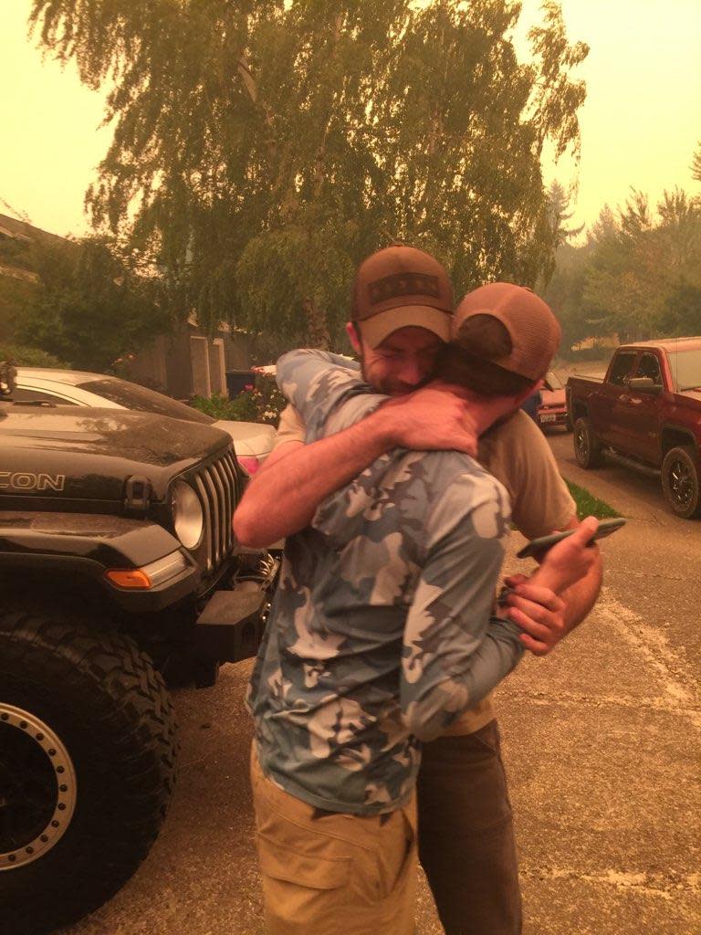 Nick and Chris Myron hug after finding out that their father is safe and alive after escaping the Beachie Creek Fire.