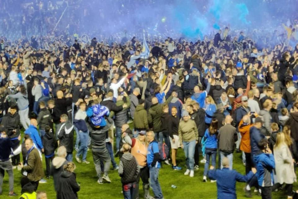 Fans run on to the pitch after Portsmouth gain promotion. <i>(Image: Brandon-Curtis Vine)</i>