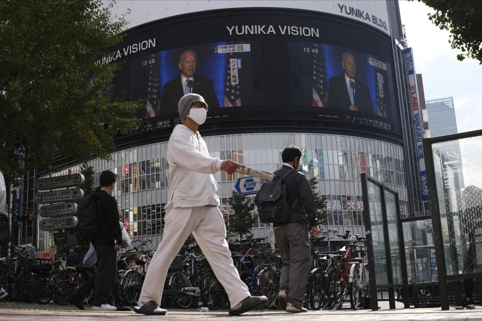 A screen shows live broadcast of President-elect Joe Biden speaking Sunday, Nov. 8, 2020 at the Shinjuku shopping district in Tokyo. (AP Photo/Kiichiro Sato)