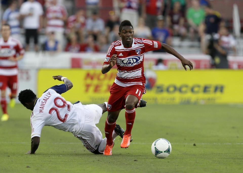 FC Dallas' Fabian Castillo (11) wins control of the ball as Real Salt Lake's Abdoulie Mansally (29) falls to the ground in the first half of an MLS soccer game Saturday, July 13, 2013, in Frisco, Texas. Real Salt Lake won 3-0. (AP Photo/Tony Gutierrez)