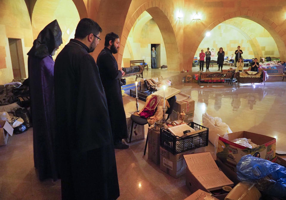 Priests conduct a service as they and parishioners take refuge in an improvised bomb shelter in the separatist region of Nagorno-Karabakh, Friday, Oct. 30, 2020. The Azerbaijani army has closed in on a key town in the separatist territory of Nagorno-Karabakh following more than a month of intense fighting. (AP Photo)