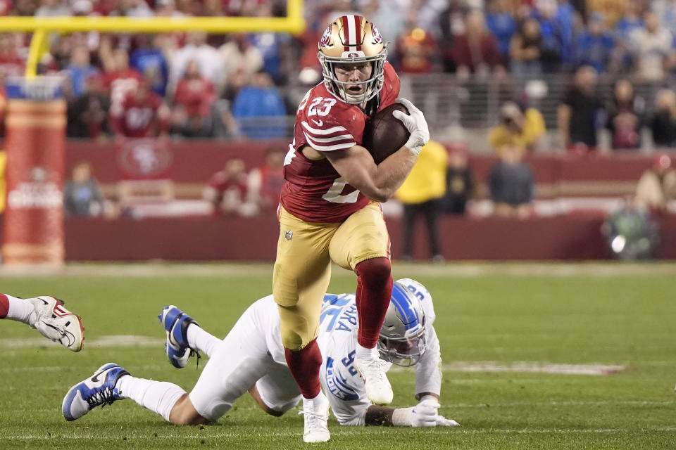 San Francisco 49ers running back Christian McCaffrey (23) runs in front of Detroit Lions defensive end Romeo Okwara during the second half of the NFC Championship NFL football game in Santa Clara, Calif., Sunday, Jan. 28, 2024. (AP Photo/Mark J. Terrill)