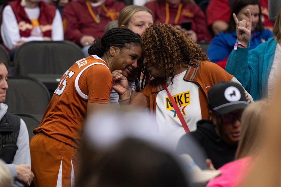 Texas freshman point guard Madison Booker celebrates in the stands after the Longhorns' 76-60 win over Kansas in the Big 12 Tournament quarterfinals on Saturday in Kansas City, Mo. Booker, this year's Big 12 co-player of the year, led Texas with 21 points.