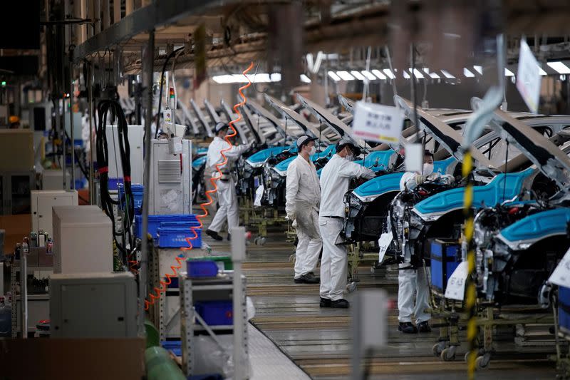 Employees work on a production line inside a Dongfeng Honda factory in Wuhan