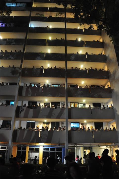 Residents gather at corridors of nearby HDB flats to watch the SDP rally in Clementi. Sunday, May 1. (Yahoo! photo/ Faris Mokhtar) 