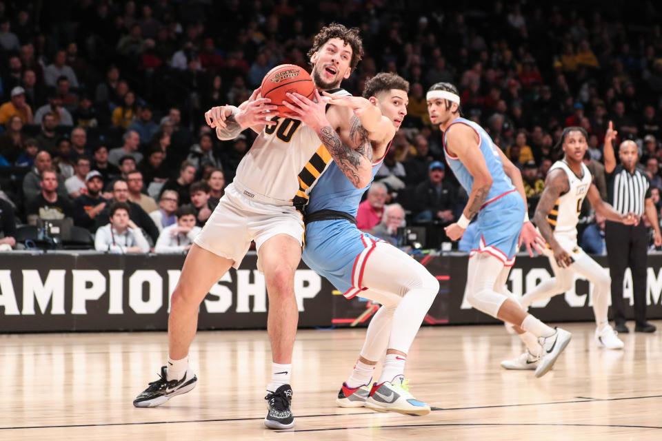 Virginia Commonwealth forward Brandon Johns Jr. (30) looks to drive past Dayton guard Koby Brea (4) in the first half of the 2023 Atlantic 10 championship game at Barclays Center.