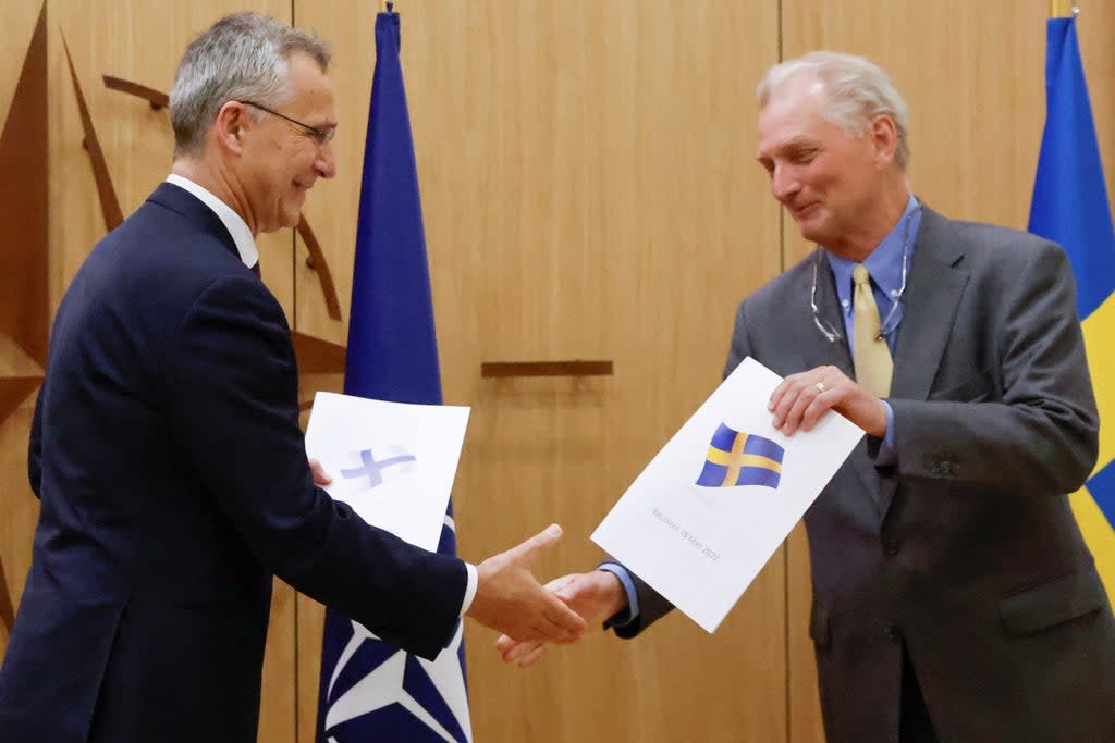 Nato Secretary-General Jens Stoltenberg and Sweden's Ambassador to Nato Axel Wernhoff shake hands during a ceremony to mark application for membership  (REUTERS)