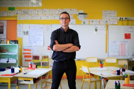 School teacher Sebastien Ducoroy poses in his classroom after an interview at the Primary School Les Ormeaux in Montereau-Fault-Yonne near Paris, France, June 18, 2018. REUTERS/Gonzalo Fuentes/Files