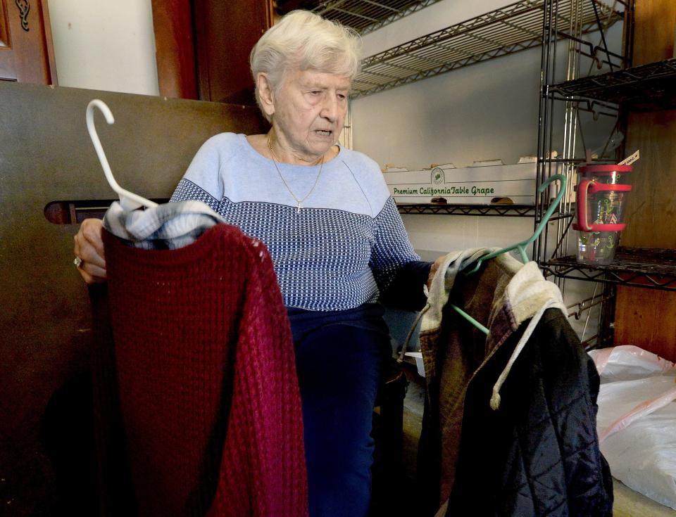 Patricia Benanti sorts clothes at St. Marin De Porres Tuesday, Nov. 7, 2023.