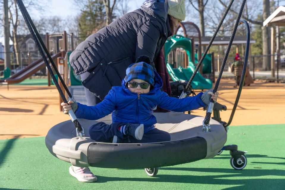Maureen Anderson prepares to swing her son Raymond at Curtis Park in Manasquan.