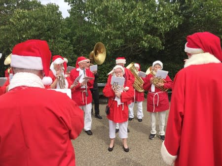 Musicians dressed as Santa Claus perform during the World Santa Claus Congress in Copenhagen