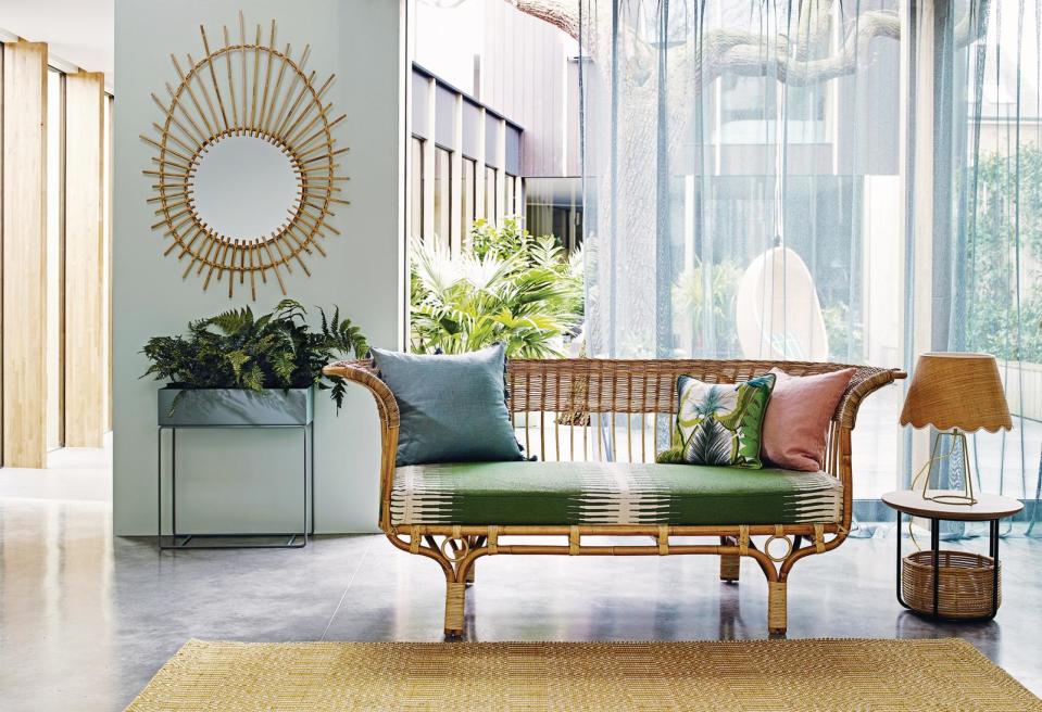 A living room with large windows and long sheer curtains