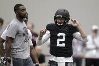 Texas A&M quarterback Johnny Manziel prepares to perform drills at pro day for NFL football representatives in College Station, Texas, Thursday, March 27, 2014. (AP Photo/Patric Schneider)