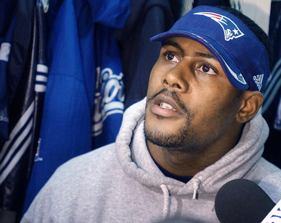 New England Patriots cornerback Ty Law speaks with reporters at his locker before team practice Wednesday, Jan. 23, 2002, at Foxboro Stadium in Foxboro, Mass. The Patriots will play the Pittsburgh Steelers in Pittsburgh Sunday for the AFC Championship. (AP Photo/Michael Dwyer)