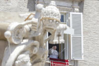 Pope Francis delivers his blessing as he recites the Angelus noon prayer from the window of his studio overlooking St.Peter's Square, at the Vatican, Sunday, June 7, 2020. Pope Francis is cautioning people in countries emerging from lockdown to keep following authorities’ rules for COVID-19 contagion containment. Says Francis: “Be careful, don’t cry victory, don’t cry victory too soon.” (AP Photo/Andrew Medichini)