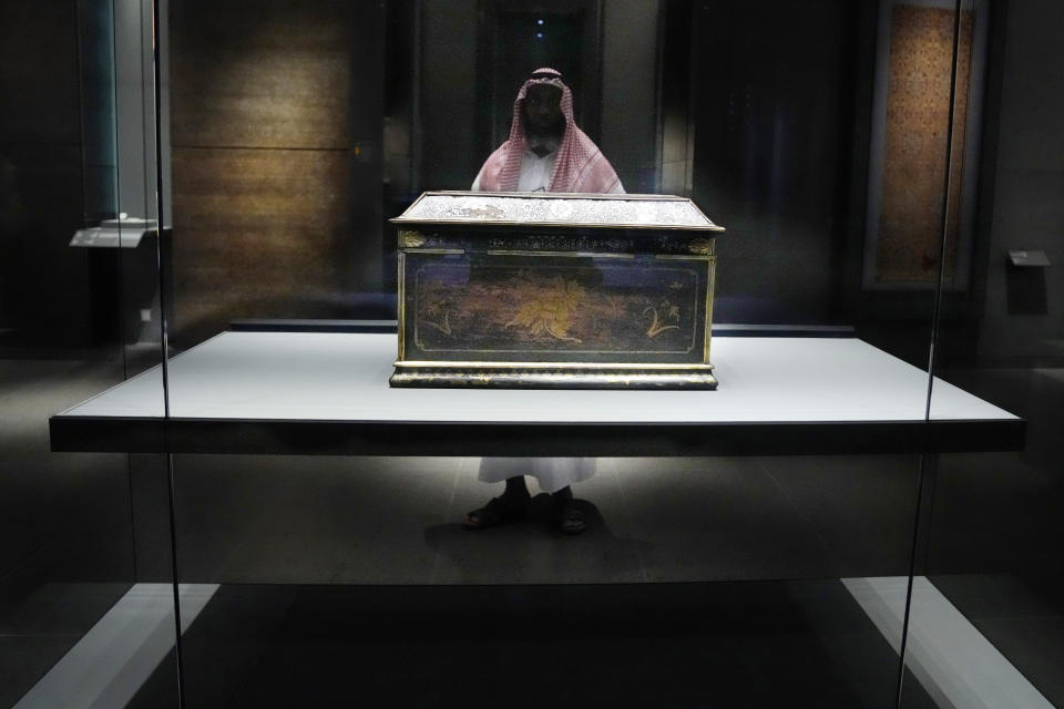 A visitor looks to an object at the Islamic Art Museum in Doha, in Doha, Qatar, Wednesday, Dec. 7, 2022. (AP Photo/Jorge Saenz)
