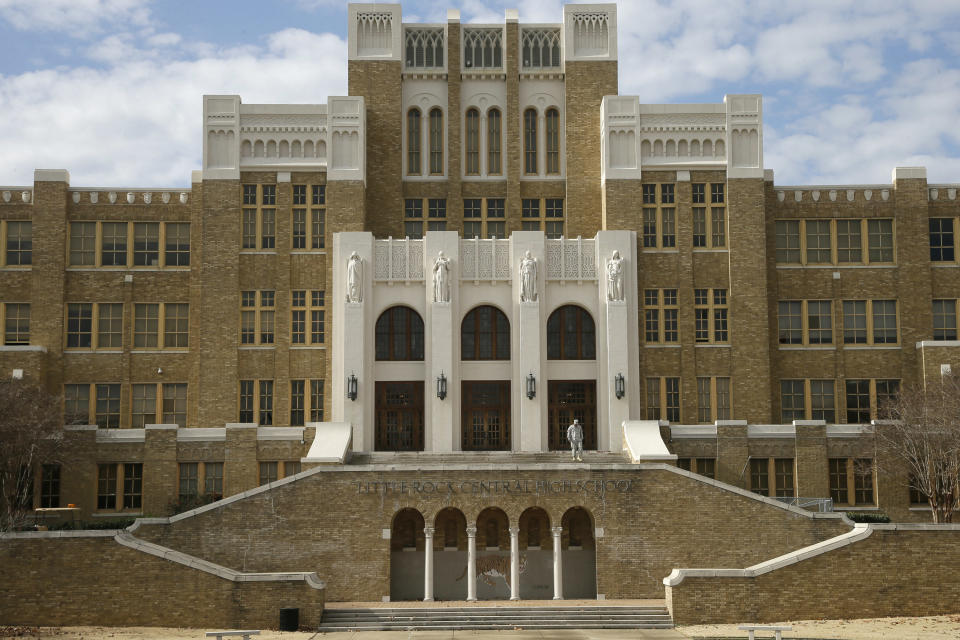 FILE - In this Monday, Jan. 13, 2014, file photo, a man walks on the stairs at Little Rock Central High School in Little Rock, Ark. Arkansas can stop making payments in one of the nation's most historic desegregation efforts, a judge has ruled, but he cautioned work remains to ensure students in the Little Rock area receive a proper education. (AP Photo/Danny Johnston, File)