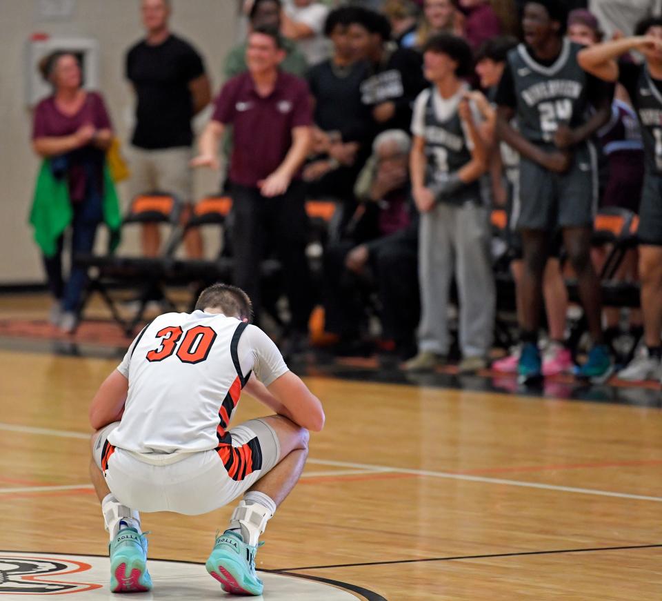 Sarasota's Johnny Lackaff (#30) experiencing the agony of defeat in overtime by four points as the Riverview Rams win 58-54 during the Class 7A-Region 3 quarterfinals Thursday evening at Eddie Howell Gymnasium in Sarasota.