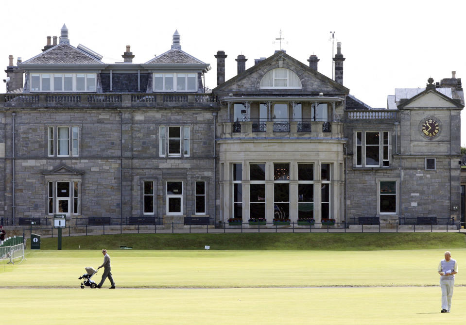 FILE - This July 7, 2010 file photo shows a view of the clubhouse at the end of the fairway on the first hole on the Old course at St Andrews golf course in St Andrews, Scotland. Wednessday, July 7, 2010. Alastair Johnston of IMG is donating his entire library, the largest in the world for golf, to the Royal & Ancient Golf Club. (AP Photo/Scott Heppell, file)