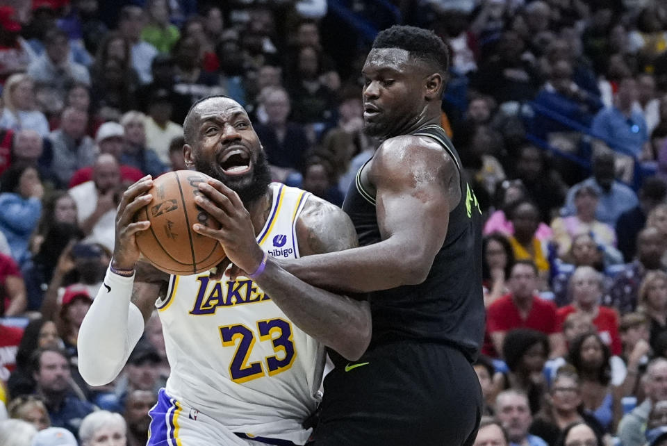 Los Angeles Lakers forward LeBron James (23) drives to the basket against New Orleans Pelicans forward Zion Williamson in the first half of an NBA basketball game in New Orleans, Sunday, April 14, 2024. (AP Photo/Gerald Herbert)