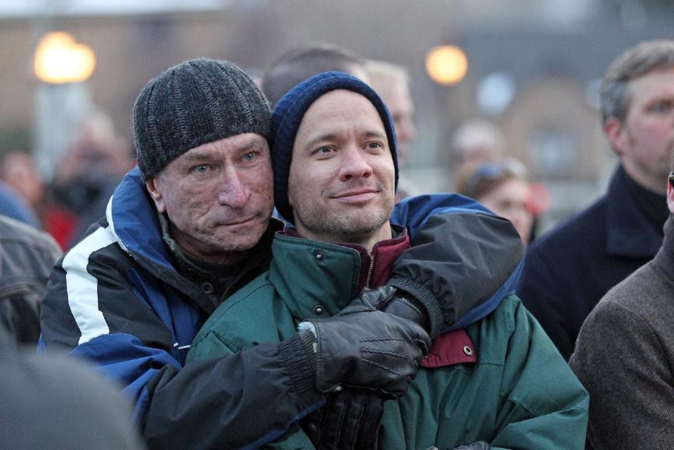 Married couple Chris Johnson, left, and David Tuma, of Ogden, Utah, hug each other during a supporters of gay marriage rally outside the Utah State Capitol, Tuesday, Jan. 28, 2014, in Salt Lake City. Johnson and Tuma were married on Dec. 28, 2013. More than 1,000 gay couples rushed to get married when a federal judge overturned Utah's constitutional amendment banning same-sex marriage in late December 2013. In early January the U.S. Supreme Court granted Utah's request for an emergency halt to the weddings. (AP Photo/Rick Bowmer)