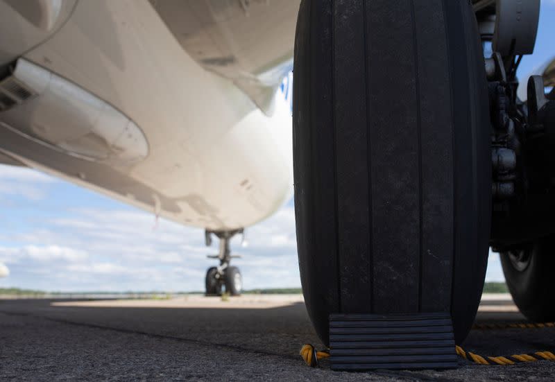 Rubber wheel chocks are seen behind the tires on an A310 airplane on the tarmac at Aerocycle in Mirabel