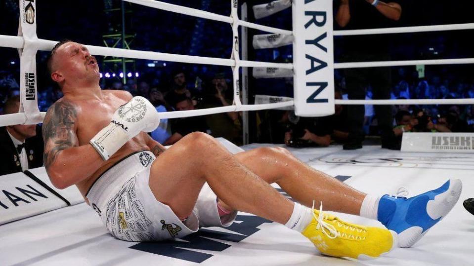 Oleksandr Usyk wincing on the canvas after being hit by Daniel Dubois