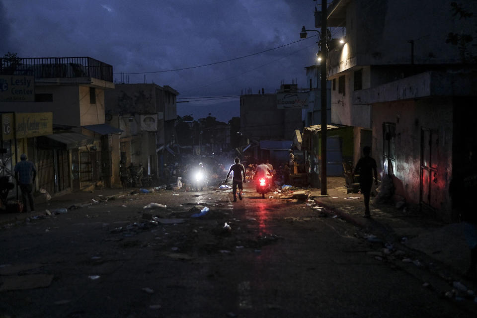 A man walks through the Petion-Ville market during a general strike in Port-au-Prince, Monday, Oct. 18, 2021. Workers angry about the nation's lack of security went on strike in protest two days after 17 members of a US-based missionary group were abducted by a violent gang. (AP Photo/Matias Delacroix)