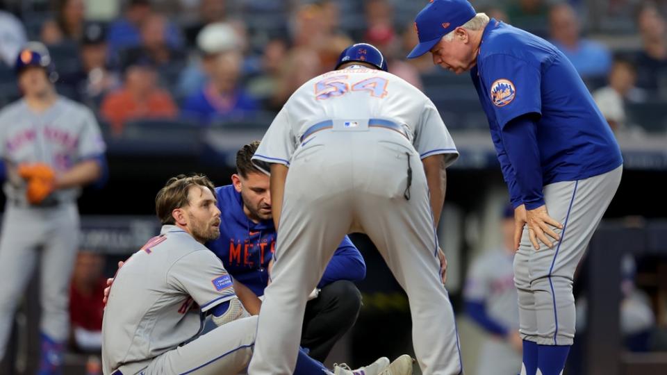Jul 26, 2023; Bronx, New York, USA; New York Mets right fielder Jeff McNeil (1) is evaluated by manager Buck Showalter (11) and first base coach Wayne Kirby (54) after being hit by a pitch during the fourth inning against the New York Yankees at Yankee Stadium.