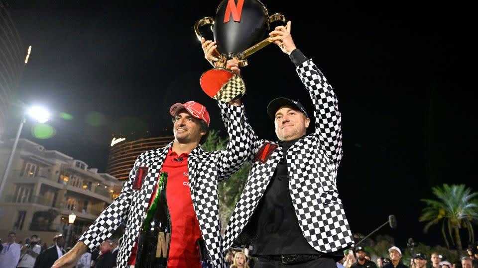 Sainz and Thomas hoist the still-intact trophy aloft. - David Becker/Getty Images for Netflix