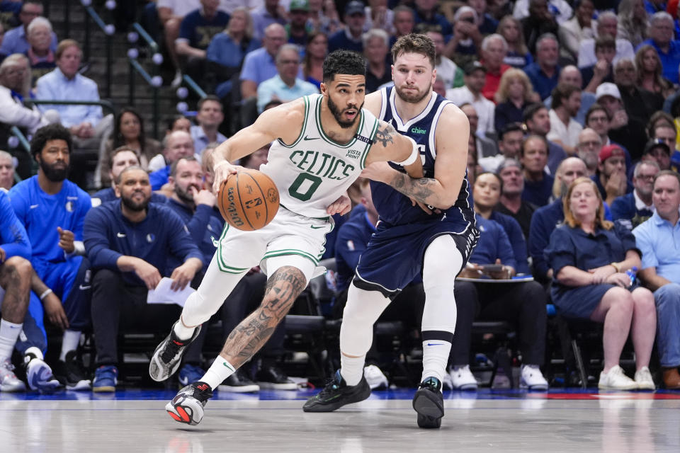 Boston Celtics forward Jayson Tatum, left, drives against Dallas Mavericks guard Luka Doncic during the second half in Game 3 of the NBA basketball finals, Wednesday, June 12, 2024, in Dallas. (AP Photo/Tony Gutierrez)