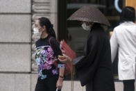 A Buddhist monk wearing a mask against the spread of the new coronavirus offers prayers in the Ginza shopping district in Tokyo Wednesday, Oct. 28, 2020. (AP Photo/Eugene Hoshiko)