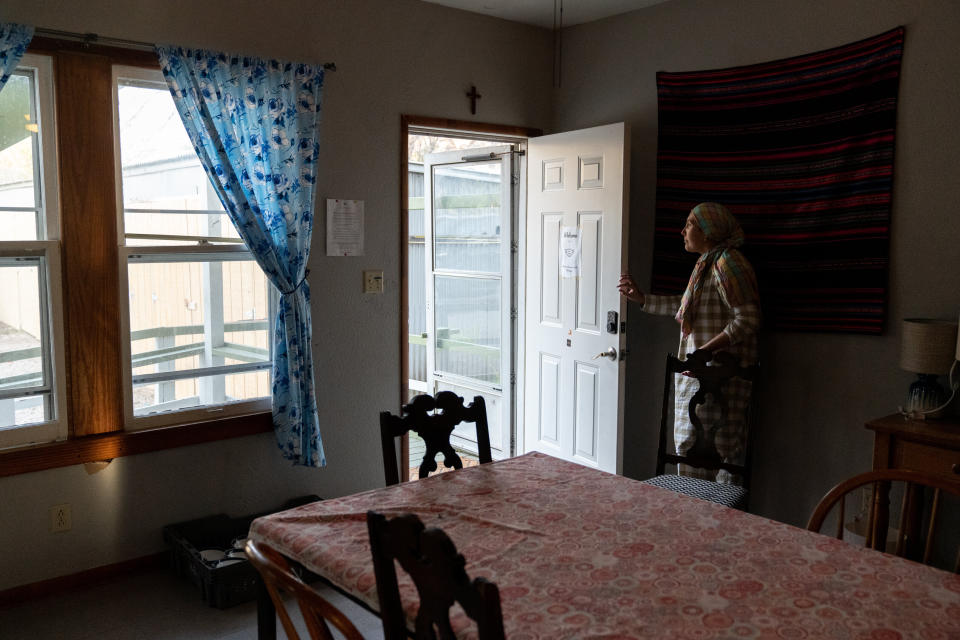 In this Feb. 4 photo, Aida opens the door of the San Antonio shelter where she and her children are staying. (Photo: Ilana Panich-Linsman for HuffPost)