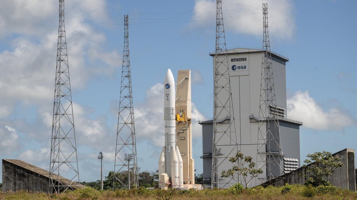  A white rocket on a launch pad. 