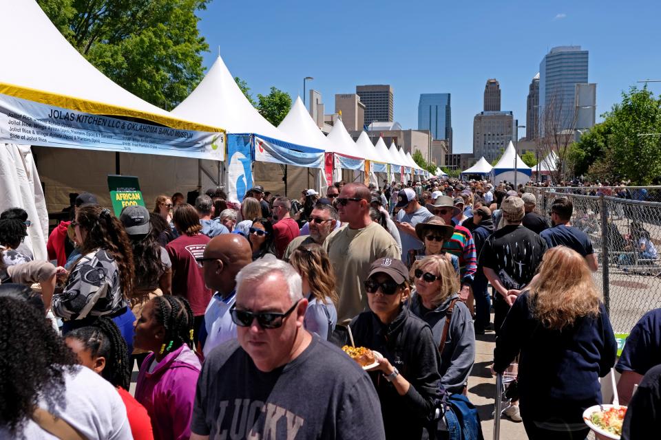 People walk past food tents during the 2023 Festival of the Arts in downtown Oklahoma City.