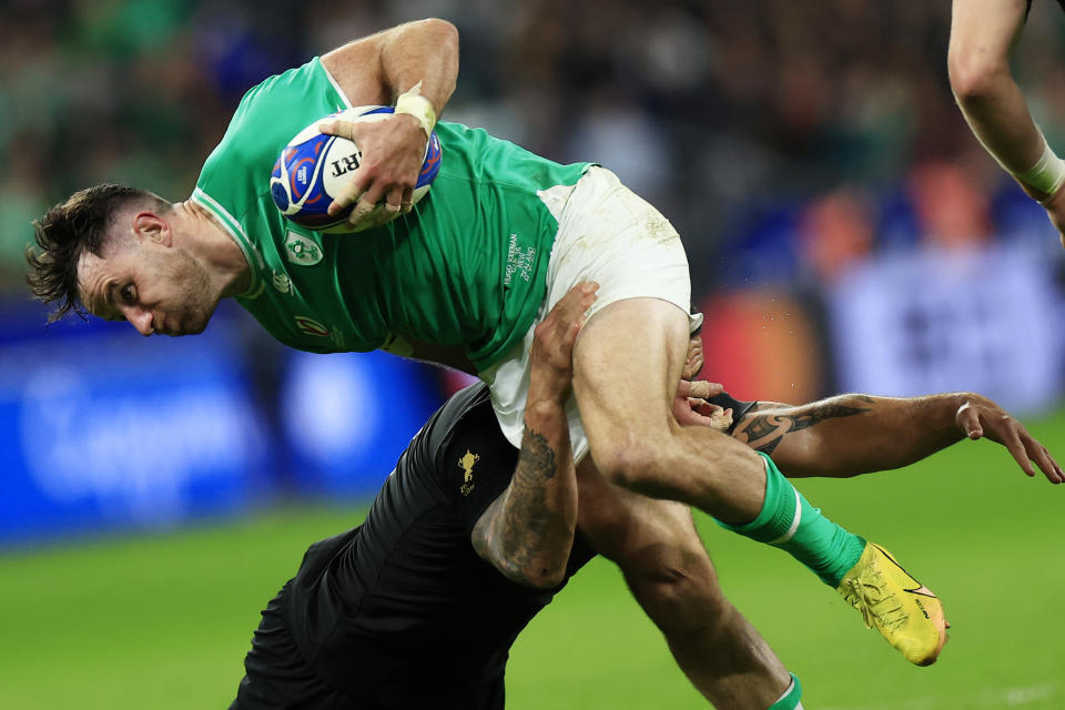 Ireland's Hugo Keenan, top, and New Zealand's Codie Taylor challenge for the ball during the Rugby World Cup quarterfinal match between Ireland and New Zealand at the Stade de France in Saint-Denis, near Paris, Saturday, Oct. 14, 2023. (AP Photo/Aurelien Morissard)